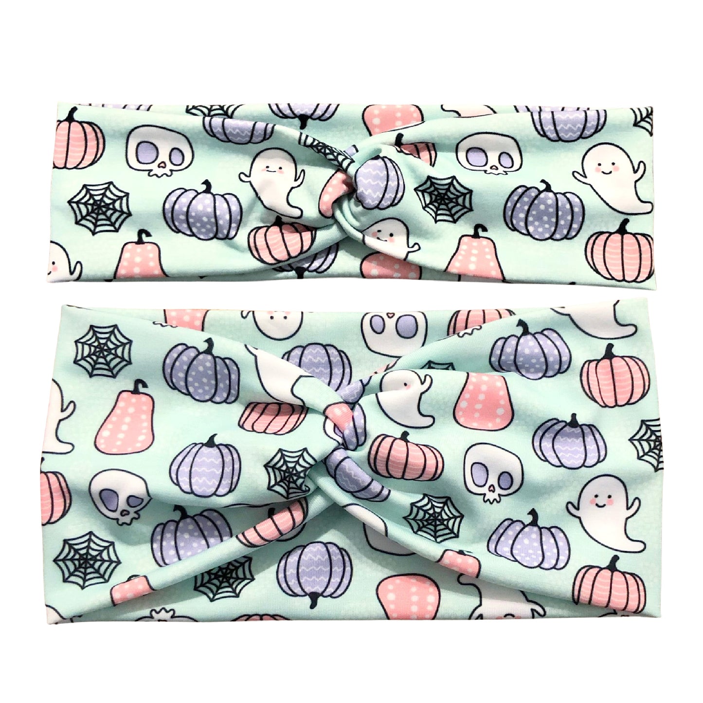 Fabric headband with Halloween-themed pattern featuring pumpkins, ghosts, and spiders on a light blue background.